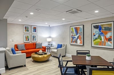 Cozy lounge area with colorful artwork and seating
