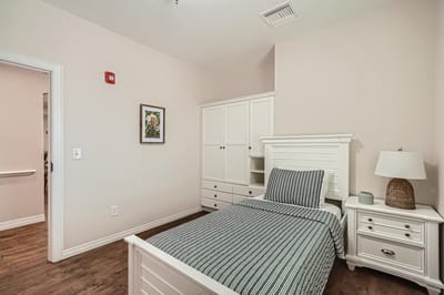Private resident room with a bed and nightstand