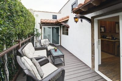 Outdoor seating area with comfortable chairs and greenery