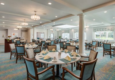 Bright interior dining room with tables set for meals