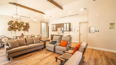A cozy common area with seating and kitchen facilities