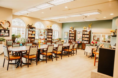 Bright interior common area with seating and bookshelves