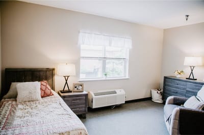 Cozy resident room with bed and seating area