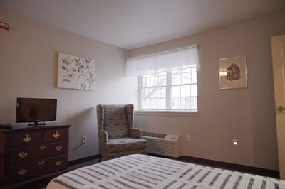 Cozy resident room with a chair and TV