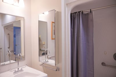 Clean bathroom with sink and shower area