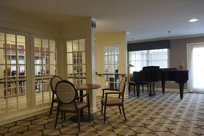 Interior view of a common area with piano and seating