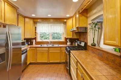 Bright kitchen with wooden cabinets and appliances