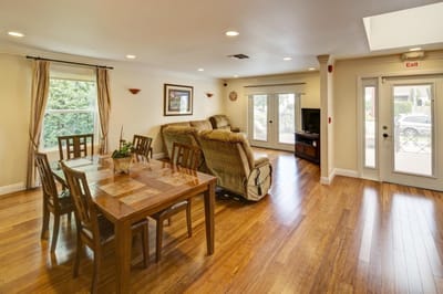 Bright common area with seating and dining table