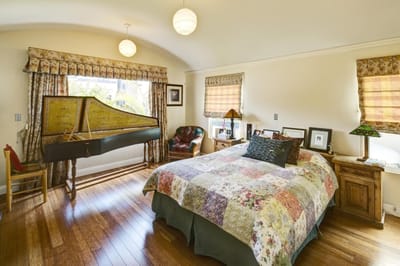 Brightly lit private resident room with a musical instrument