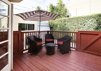 Outdoor seating area with chairs and umbrella