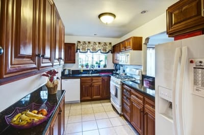 A warm kitchen area with wooden cabinets and countertops