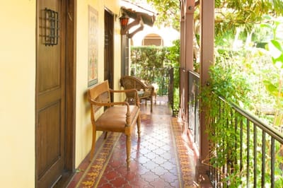 A sunny corridor with seating and rich tile flooring
