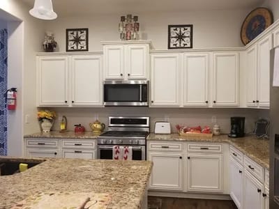Modern kitchen interior with white cabinets and appliances