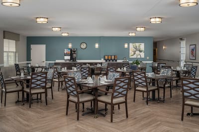 Dining room with neatly set tables and chairs