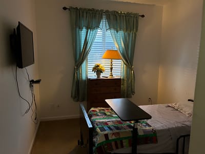 Private resident room with window and furnishings