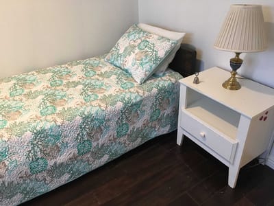 Private resident room with a bed and lamp