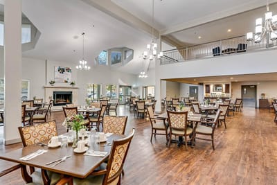 Bright and spacious dining room with tables and chairs