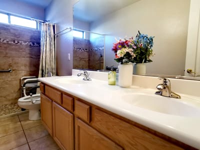 A well-decorated bathroom with floral arrangement