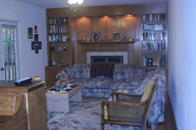 A cozy common area with a bookshelf and couch
