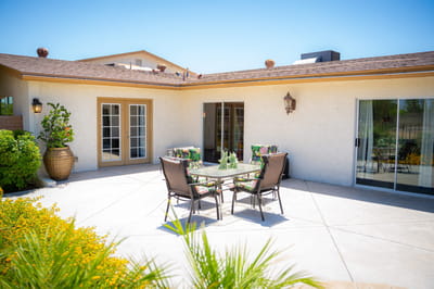 Outdoor patio seating area with dining table and chairs