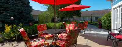 Outdoor seating area with bright umbrellas and flowers