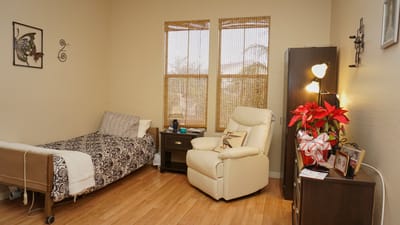 Cozy private room with a bed, chair, and decor