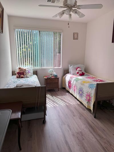 A cozy resident room with two beds and decorations