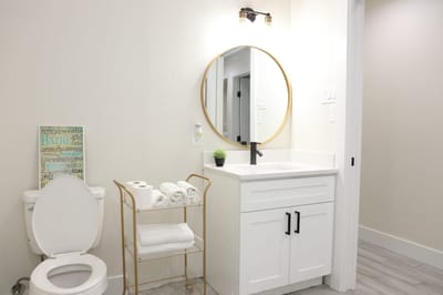Modern bathroom with a round mirror and towels
