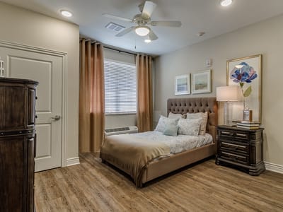 Cozy private resident room with bed and furnishings
