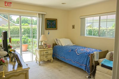 A cozy resident room with a bed and decorations