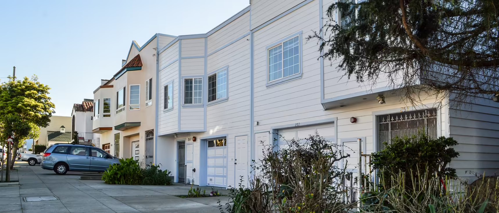 Street view of Merced Residential Care I with trees and parked cars.