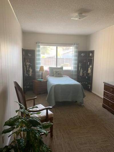 Cozy private resident room with bed and decor