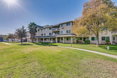Front view of The Remington Senior Living building and outdoor space