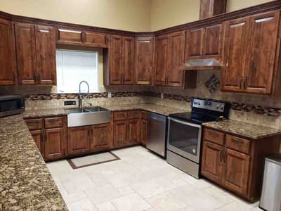 Modern kitchen with wooden cabinets and stainless steel appliances