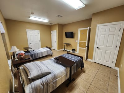 Shared resident room with two beds and a television