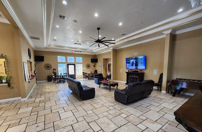 Interior view of a common area with seating and a television