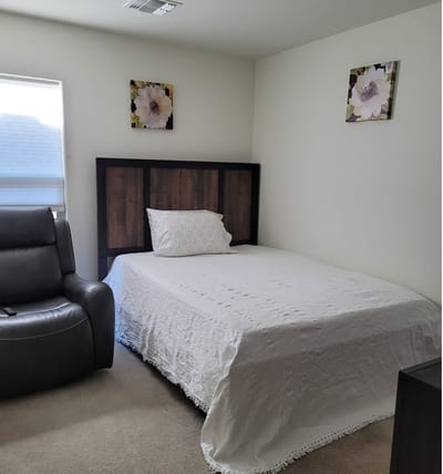 Cozy resident room with a bed and armchair