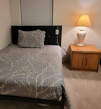 Cozy resident room with bed and lamp