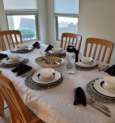 A beautifully set dining table with dishes and utensils