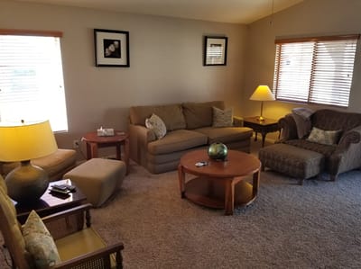 Cozy common area with seating and lamp.