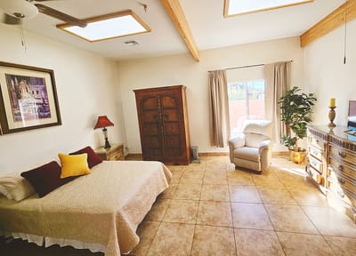 Bright and inviting private room with a bed and armchair