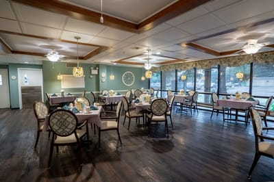 Dining area with tables and chairs set for meals