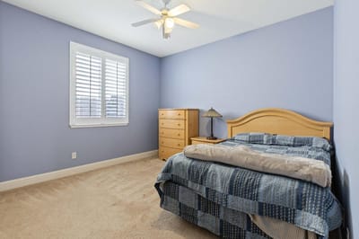 Bright, simple interior of a resident room with a bed
