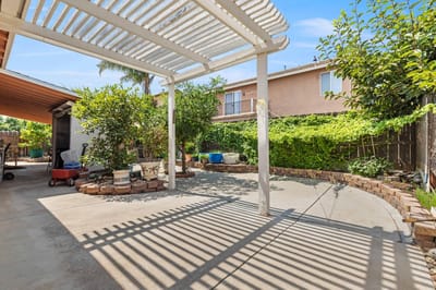 Outdoor patio area with greenery and shaded seating