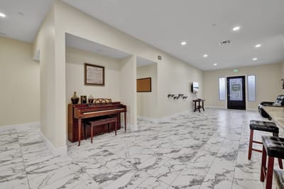 Modern lobby area with a piano and seating
