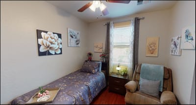 Cozy resident room with floral decor and a recliner