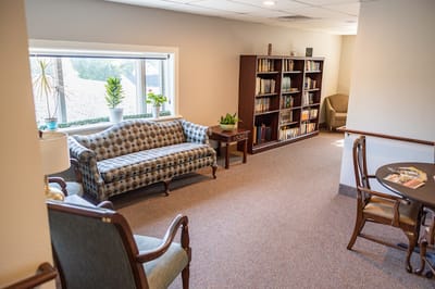 Cozy common area with seating and bookshelves