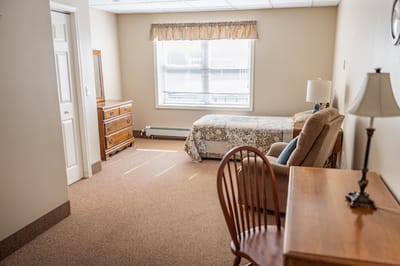 Cozy interior of a resident's room with a bed and furniture