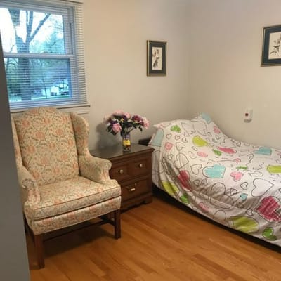 Cozy resident room with a bed and chair