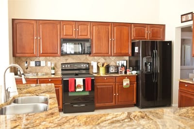 Bright kitchen area with wooden cabinets and appliances